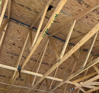 Roof trusses and sheathing over the garage addition at framing, seen from the floor